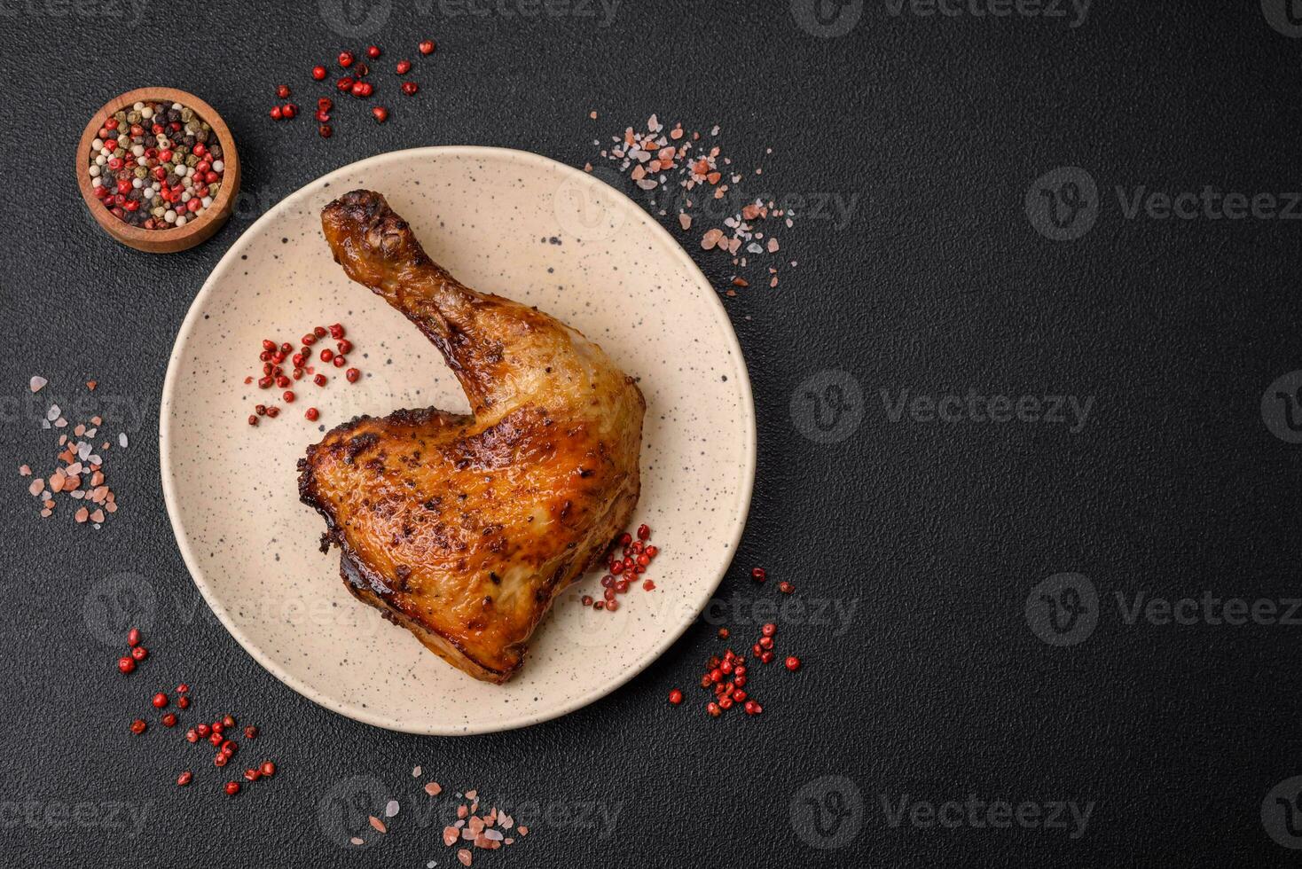 Delicious grilled chicken leg or quarter with salt and spices photo