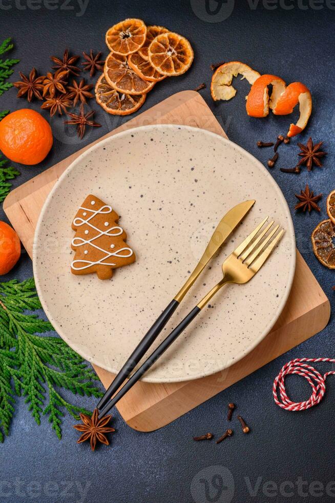 Beautiful festive Christmas composition of an empty plate, tangerine and gingerbreads photo