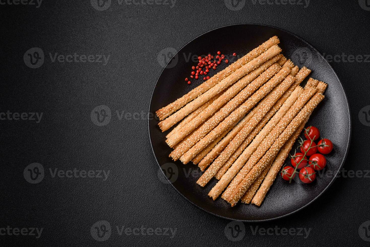 Delicious fresh grissini sticks with salt and sesame seeds photo