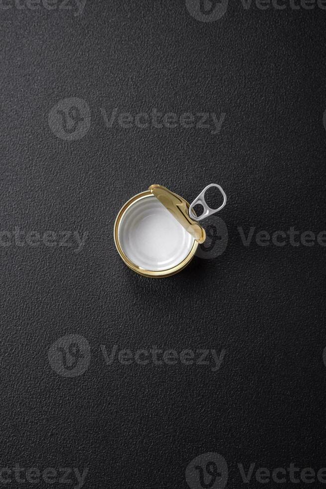 Empty round uncorked metal can for canned meat or fish photo