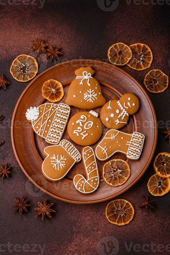 Beautiful Christmas gingerbread cookies of different colors on a ceramic plate photo