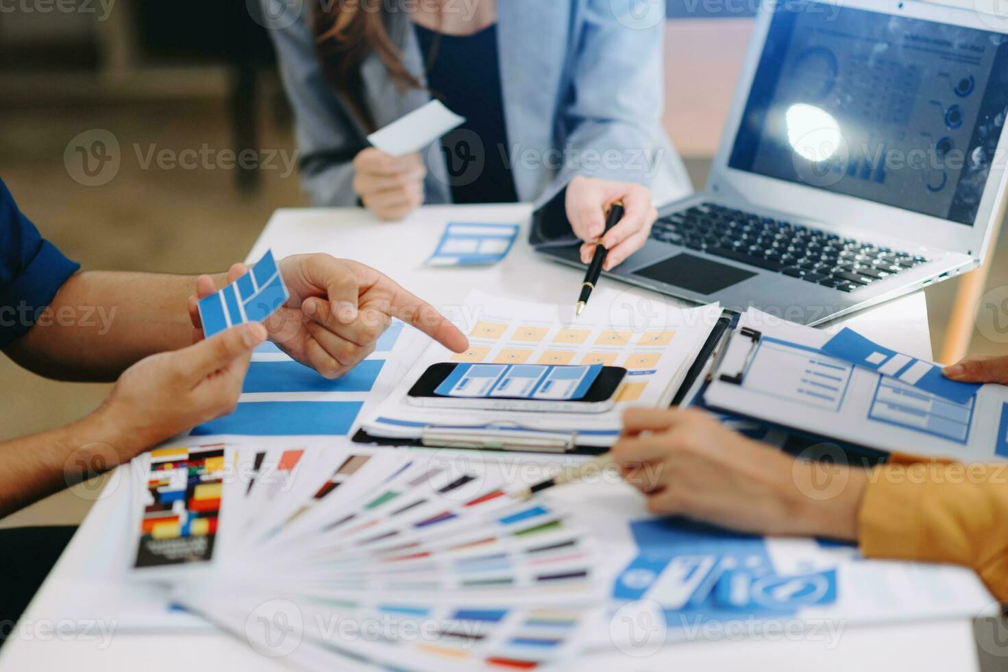 UX developer and ui designer brainstorming about mobile app interface wireframe design with customer breif and color code photo