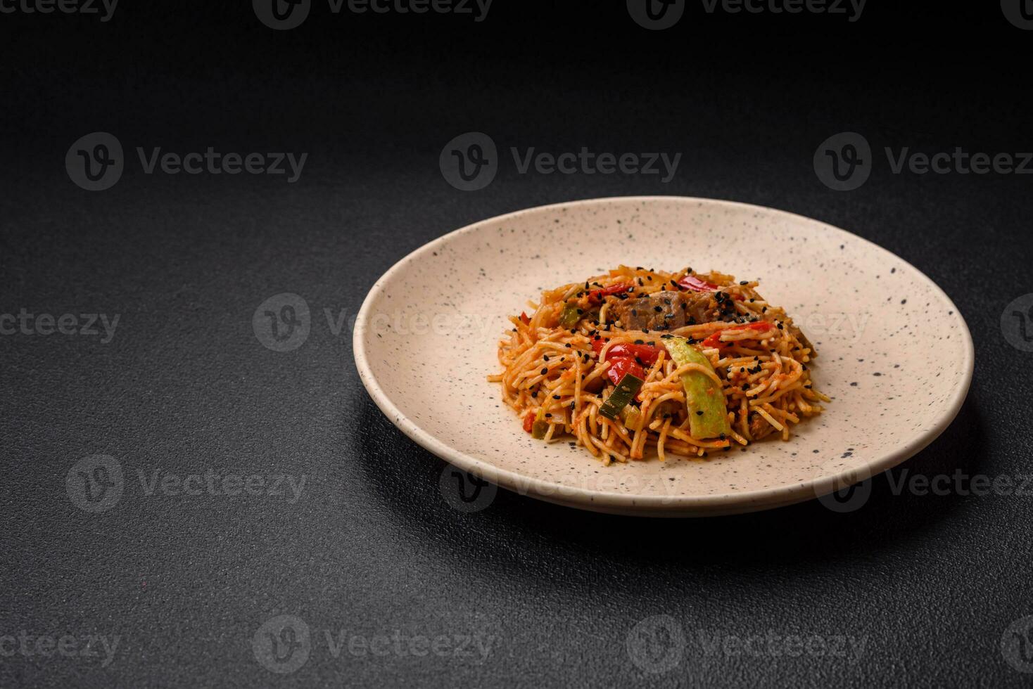 Delicious udon noodles with meat or seafood, vegetables, salt and spices photo