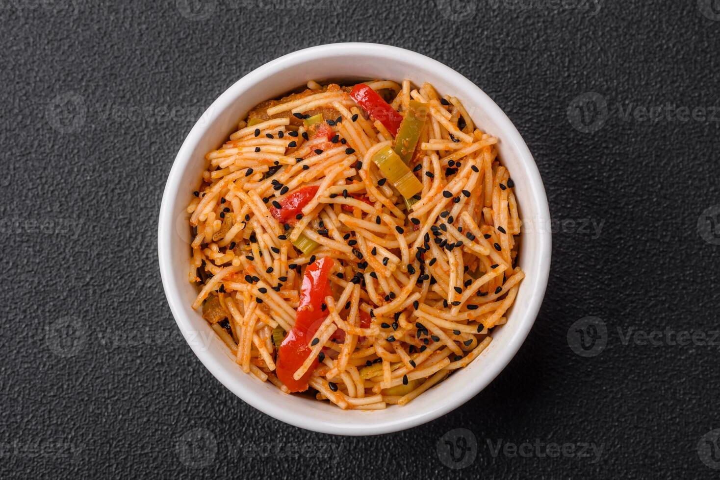 Delicious udon noodles with meat or seafood, vegetables, salt and spices photo