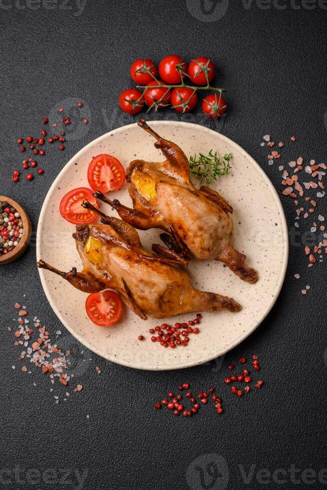 Roasted quail, partridge or pigeon stuffed with orange with spices and herbs photo