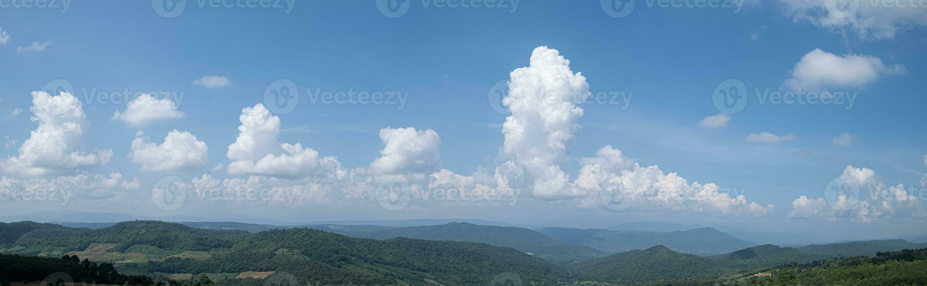 Mountain view and blue sky with white clouds photo