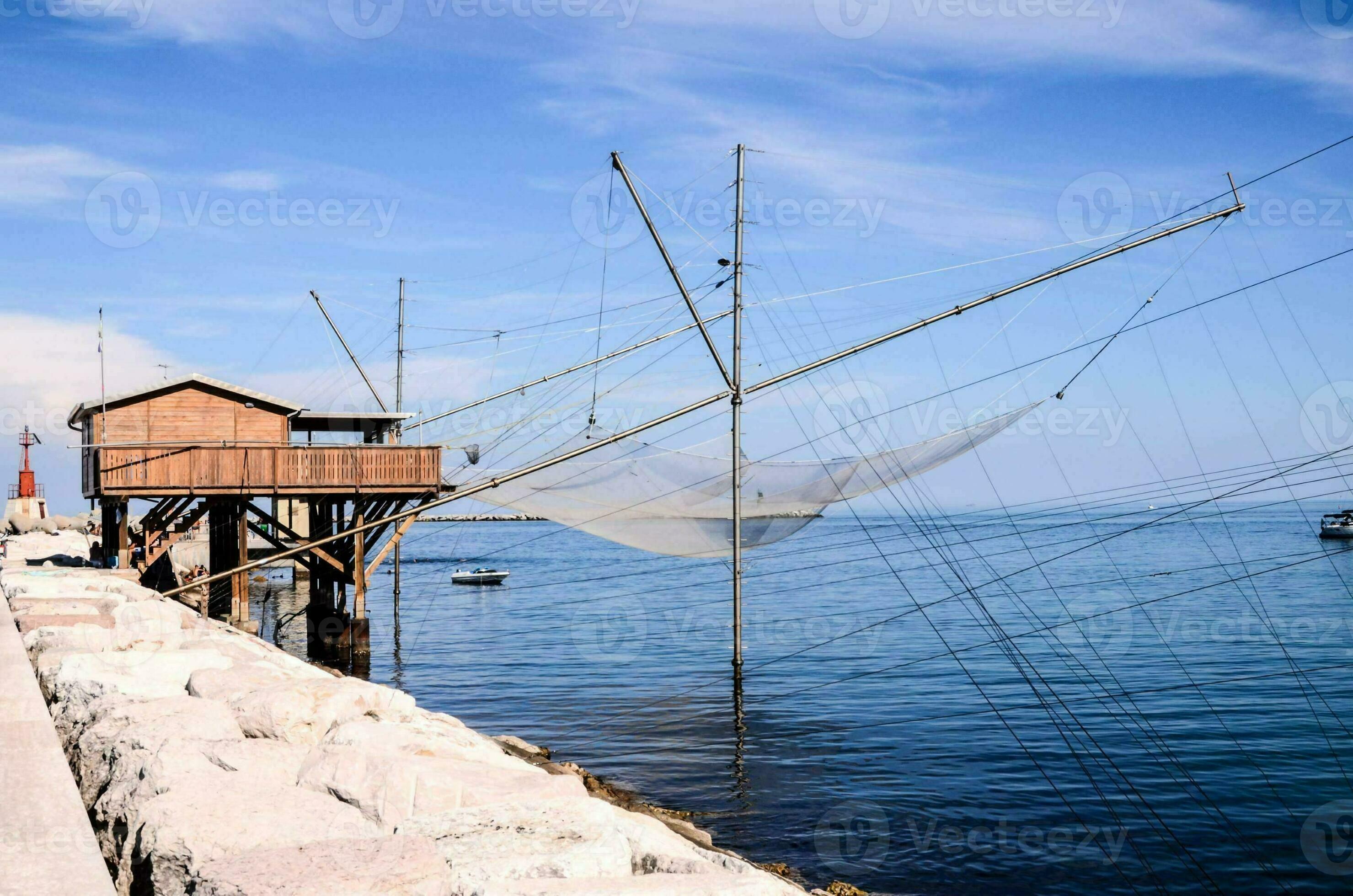 a fishing net is hanging from a pier 34729922 Stock Photo at Vecteezy