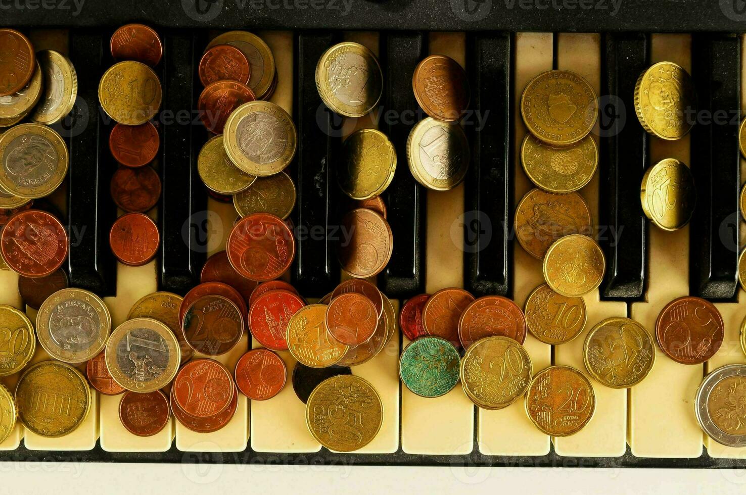 a piano keyboard with coins on it photo