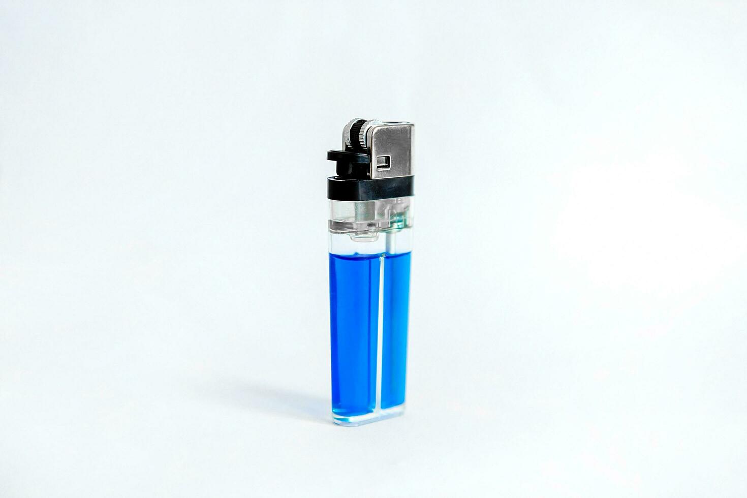 Blue plastic lighter on white background photo