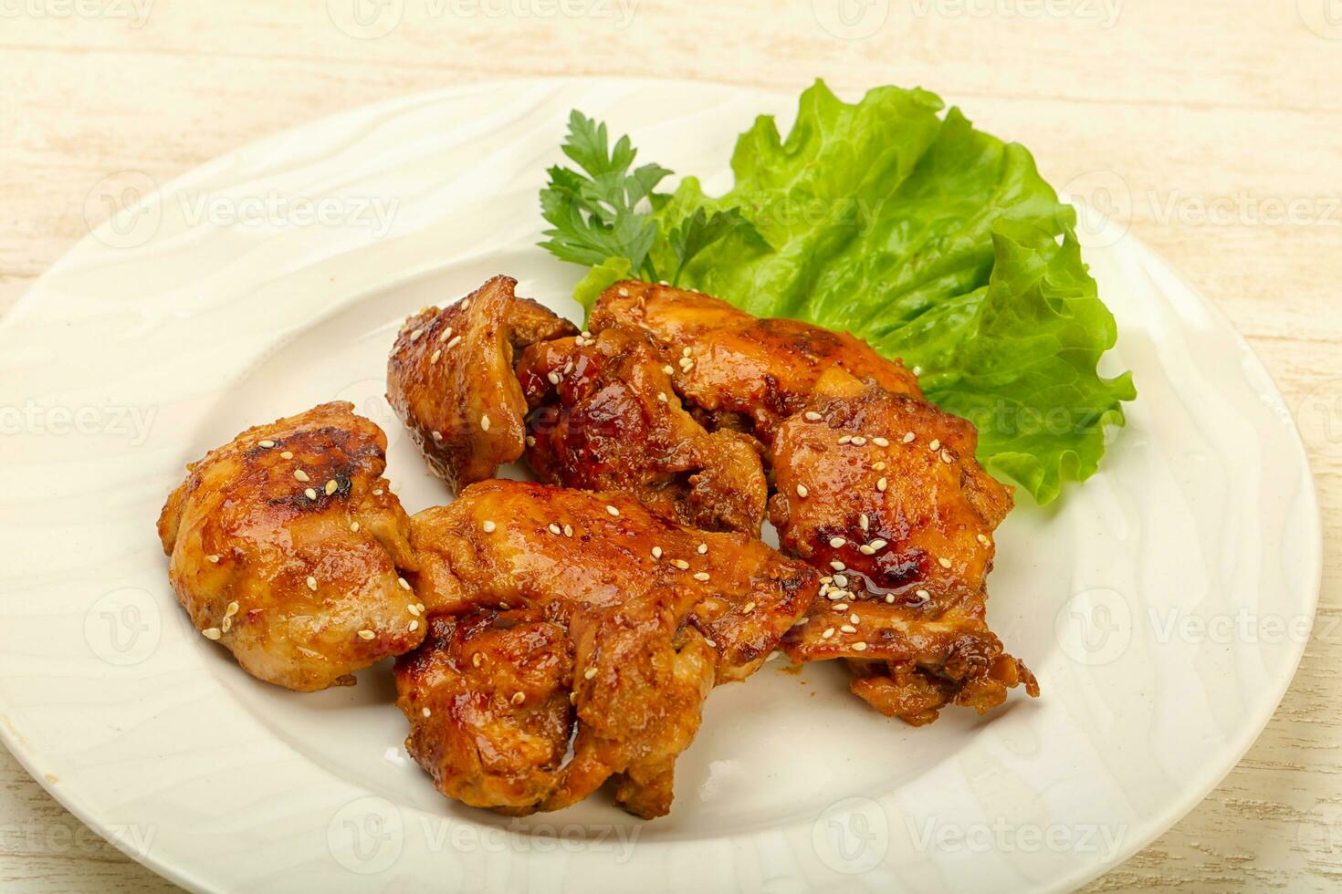 Teriyaki thighs over wooden background photo