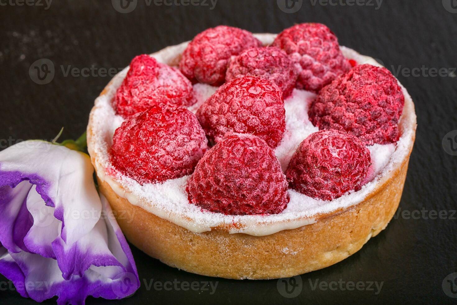 Raspberry cake over wooden background photo