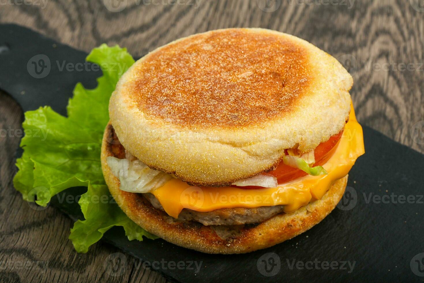 Cheeseburger over wooden background photo