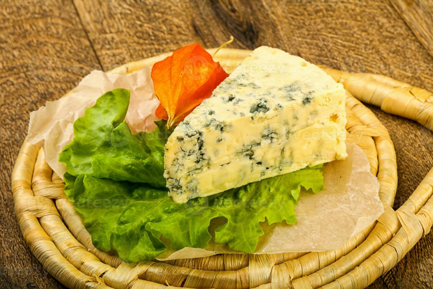 Blue cheese over wooden background photo