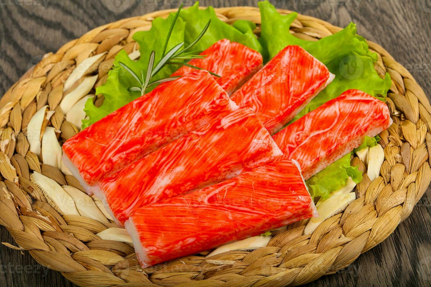 Crab sticks over wooden background photo
