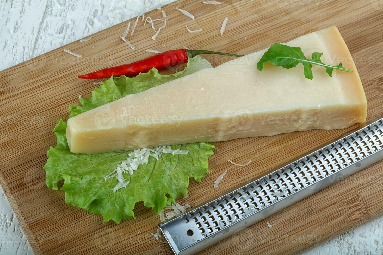 Parmesan cheese over wooden background photo