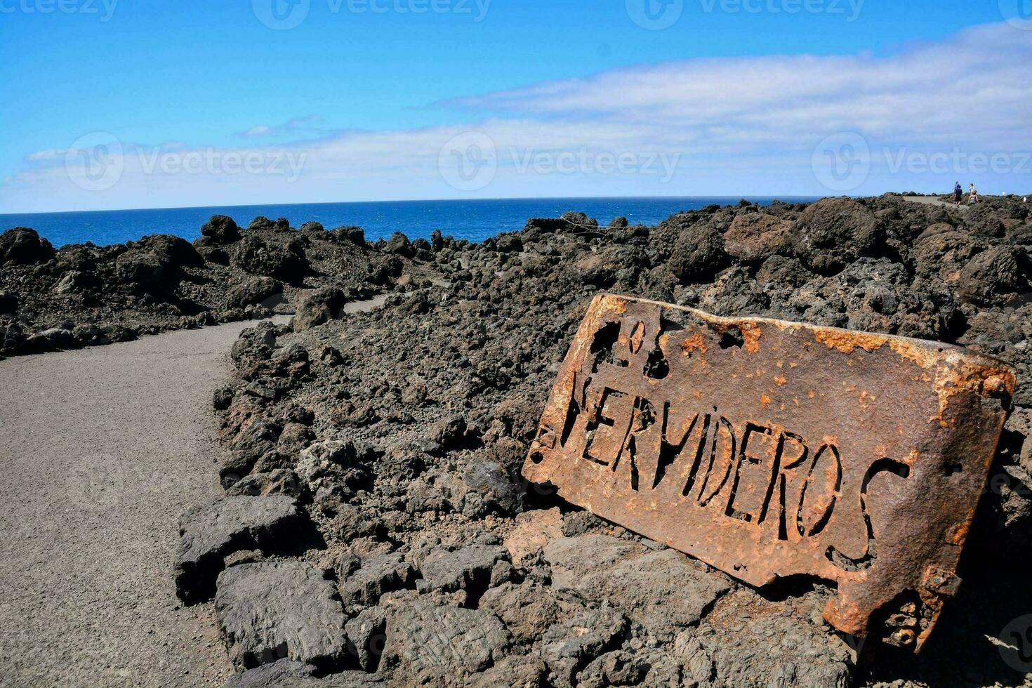 a beach with rocks and sand on it photo