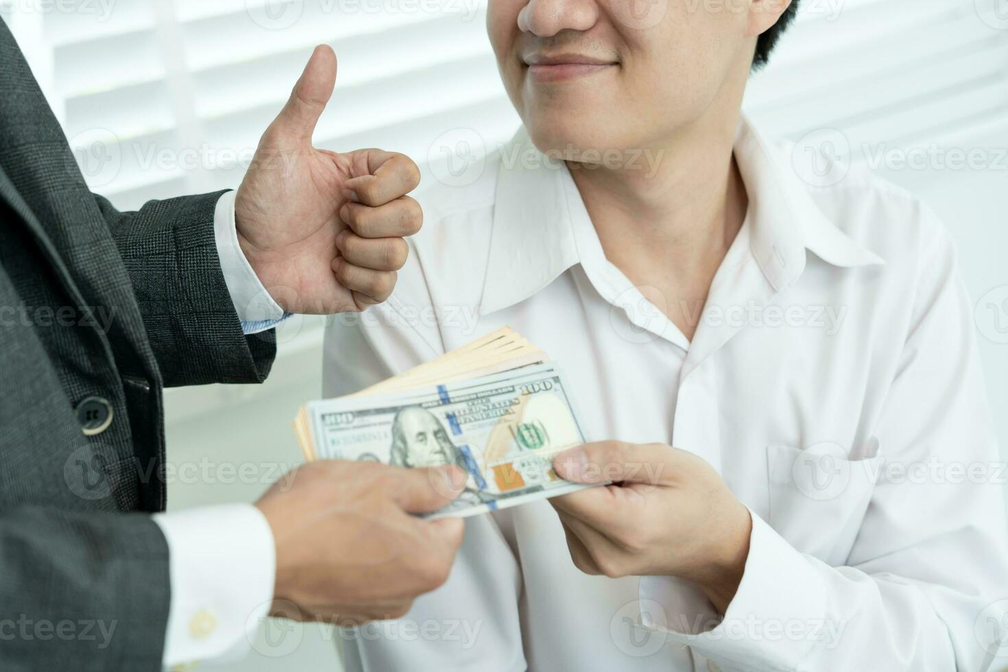 Businessmen receive salary or bonuses from management or Boss. Company give rewards to encourage work. Smiling businessman enjoying a reward at the desk in the office. photo