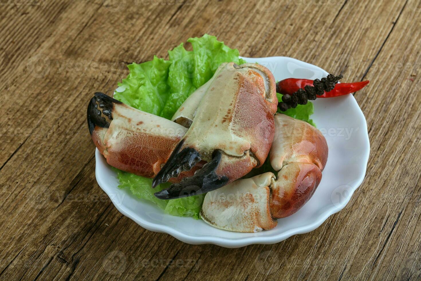 Crab claws over wooden background photo