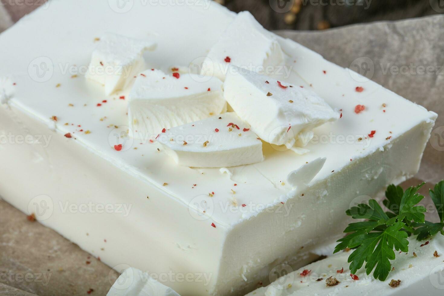 Feta cheese over wooden background photo