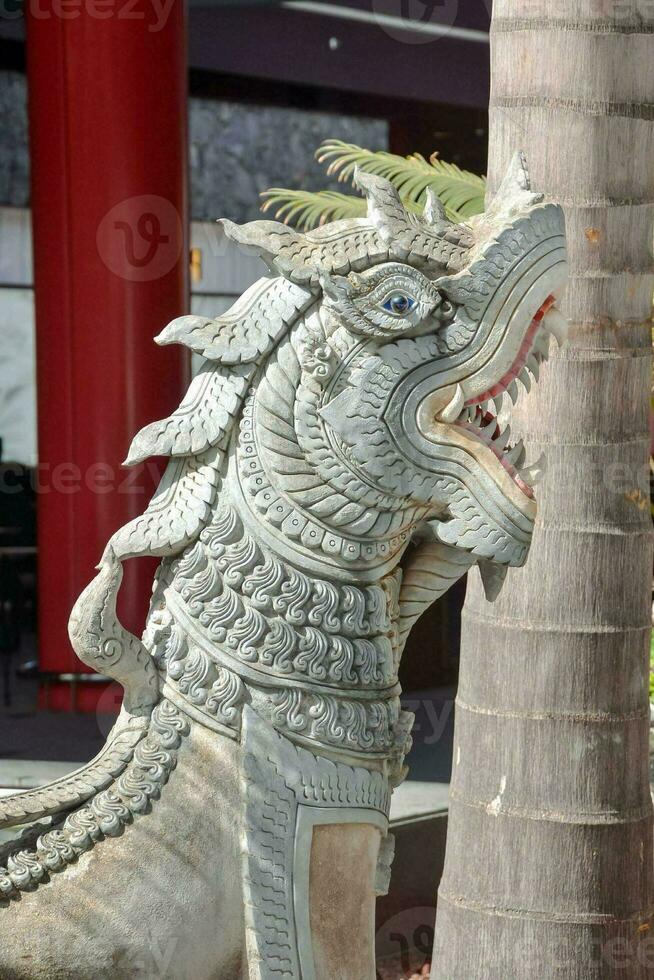 a statue of a dragon in front of a building photo