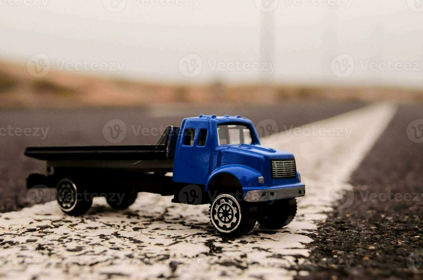 a toy truck is parked on the road photo