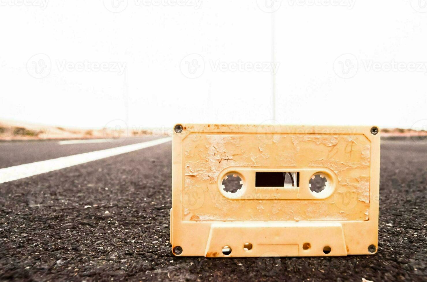 an old cassette sitting on the side of a road photo