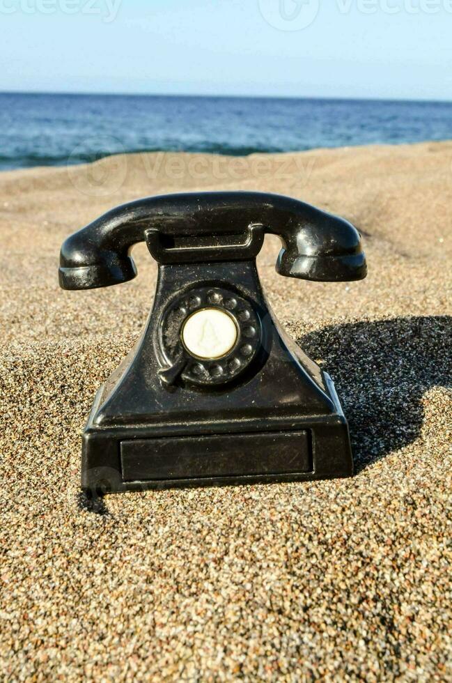 an old telephone on the beach photo