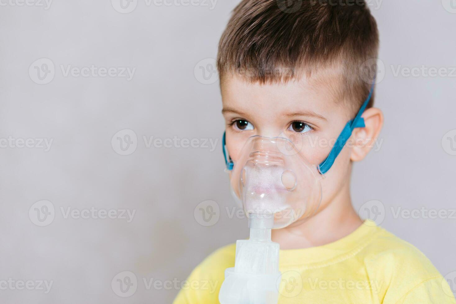 small child treats bronchitis inhaler at home photo