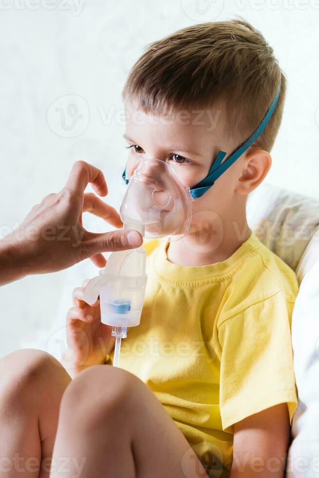 mother treats bronchitis in a child with a nebulizer photo