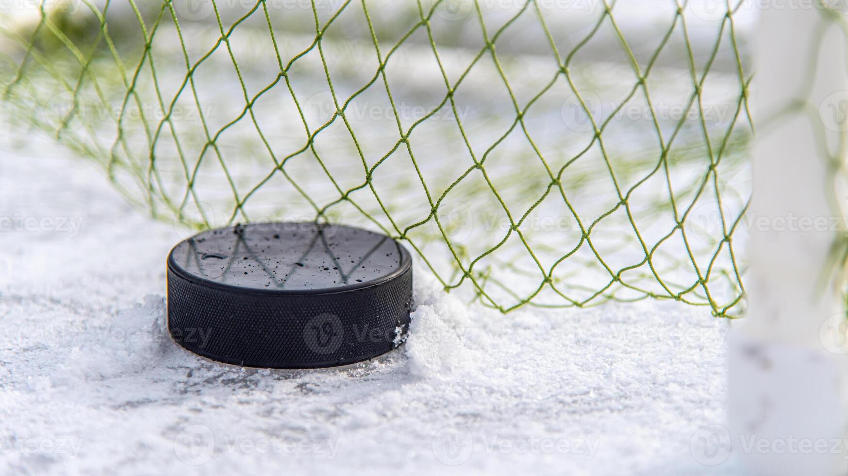 hockey puck in the goal net closeup 34733216 Stock Photo at Vecteezy