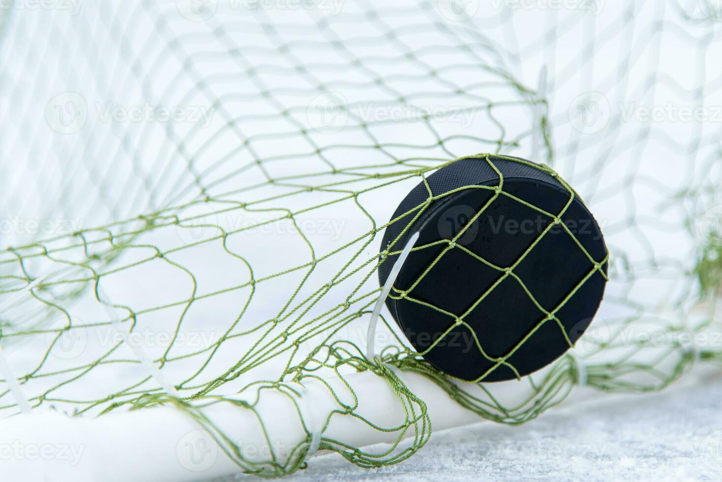goal scored by a hockey puck in the goal net photo