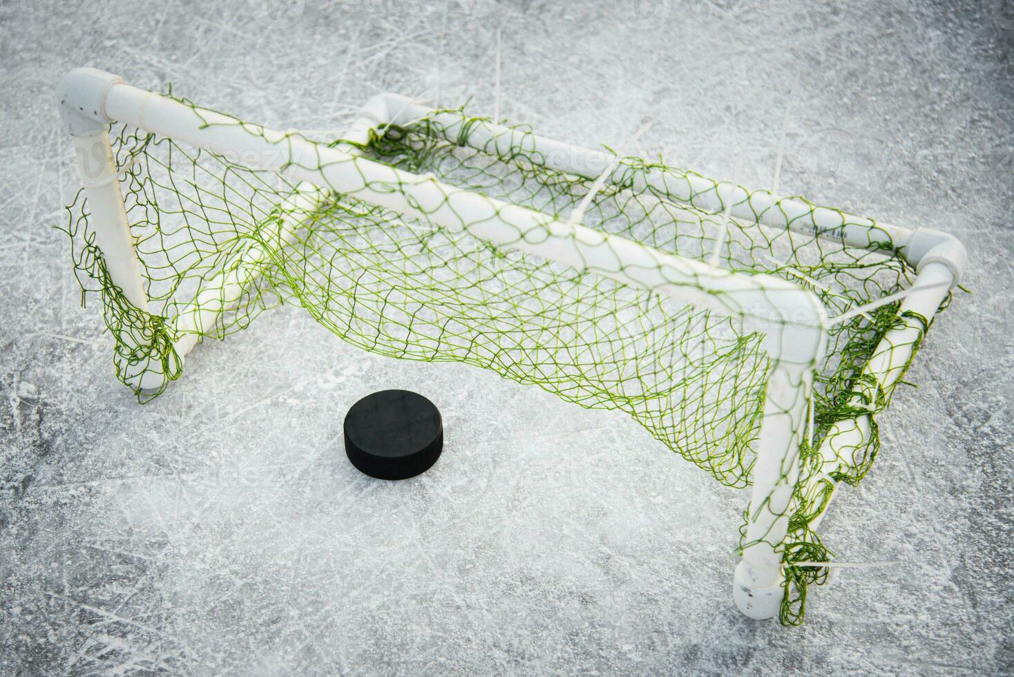 goal scored by a hockey puck in the goal net photo
