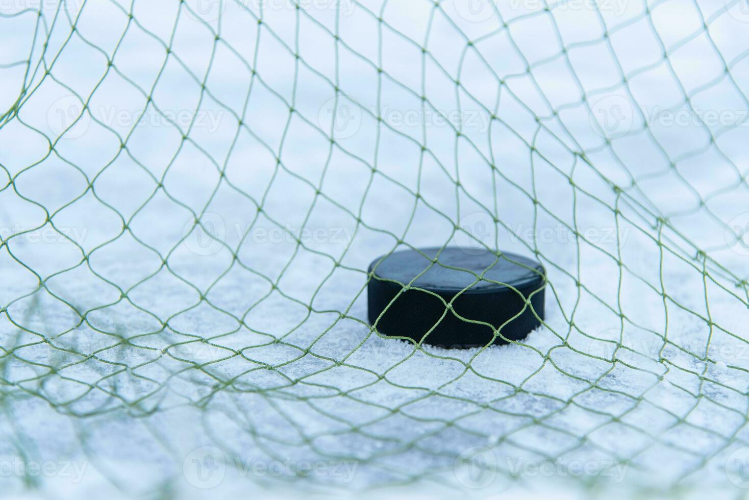 goal scored by a hockey puck in the goal net photo