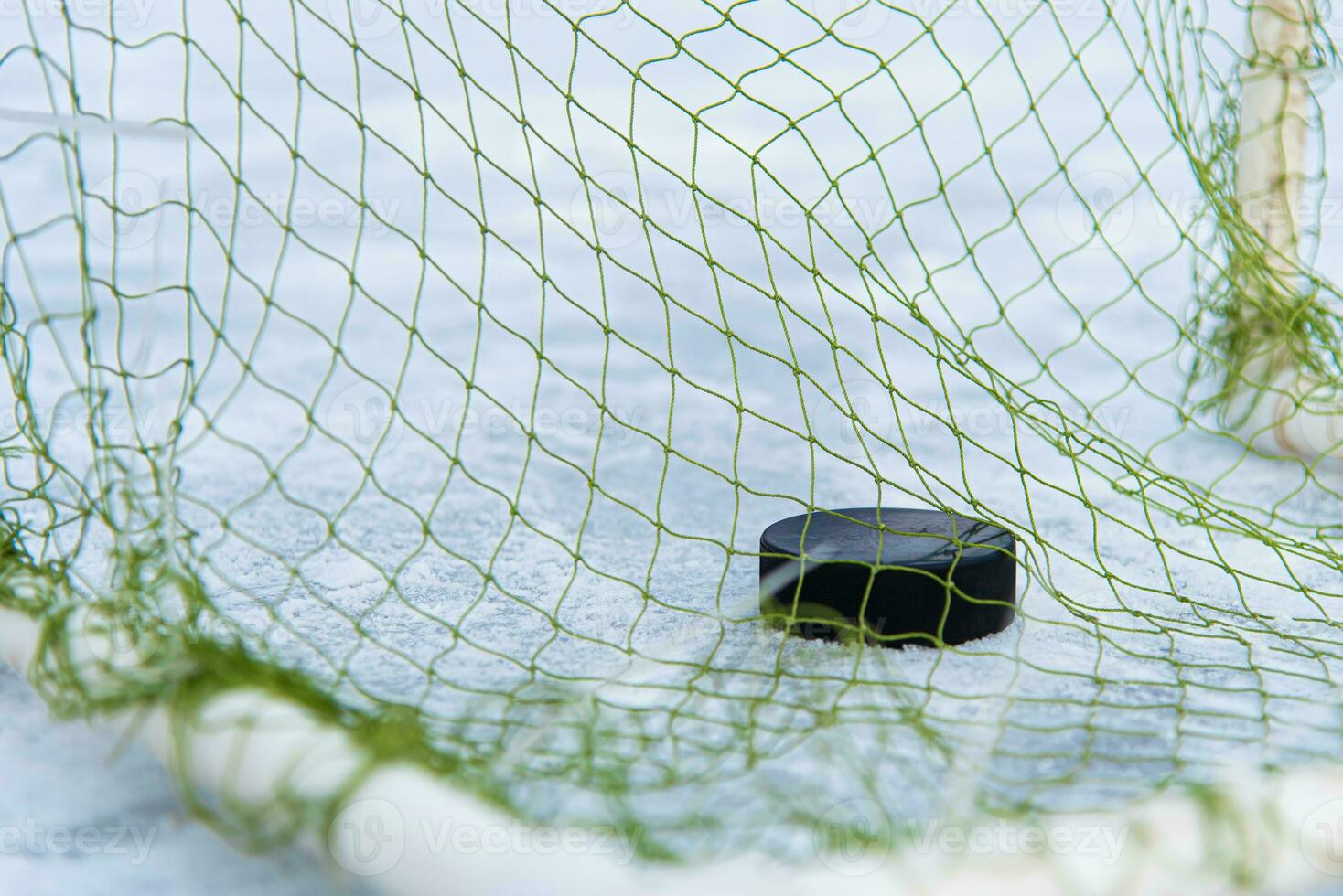 goal scored by a hockey puck in the goal net photo