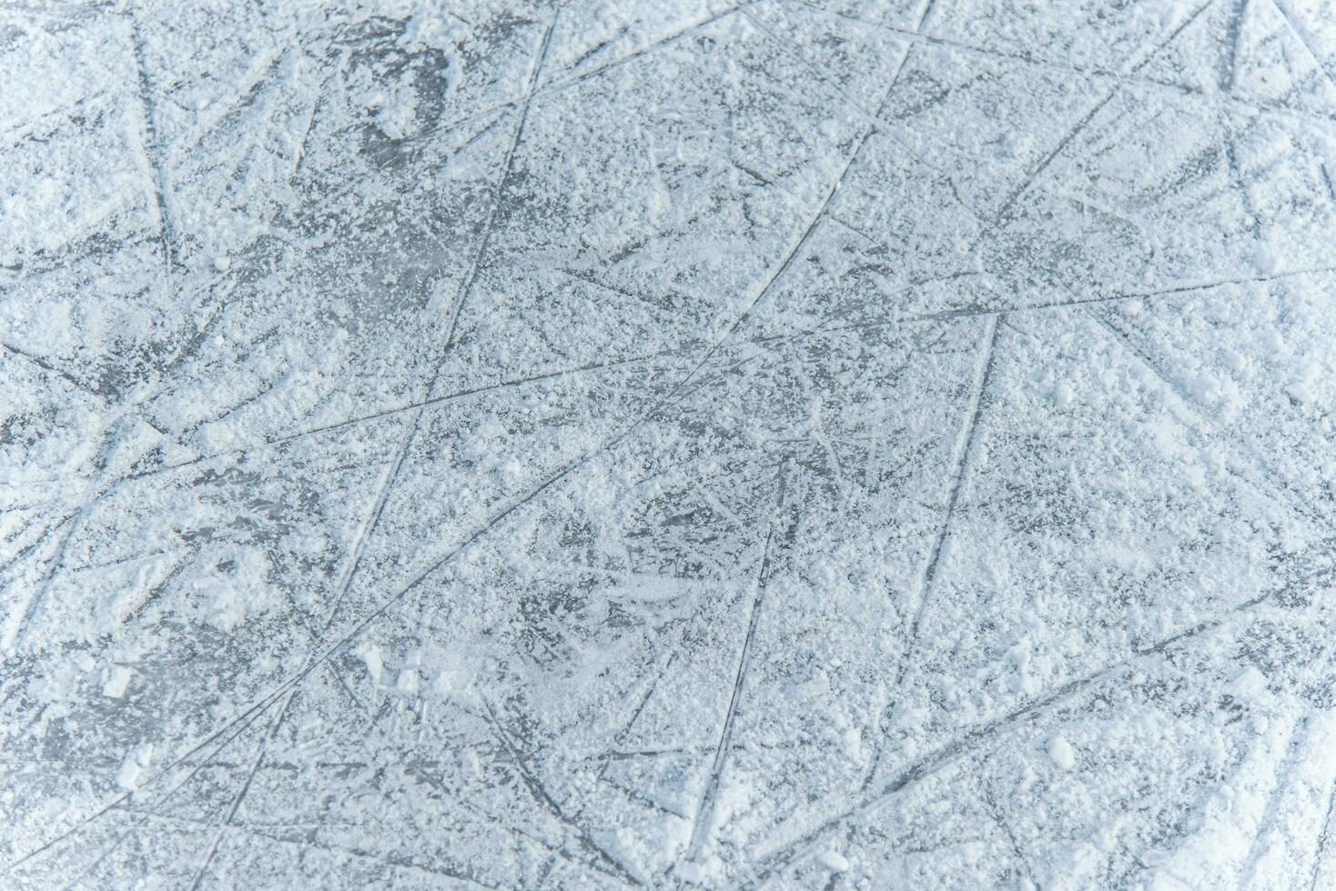 traces on the ice from skates on the rink photo