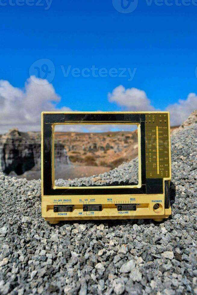 a small television on top of a rocky cliff photo
