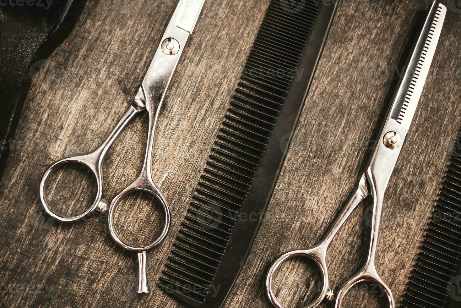 combs and scissors for haircuts lie on a shelf in the cabin photo