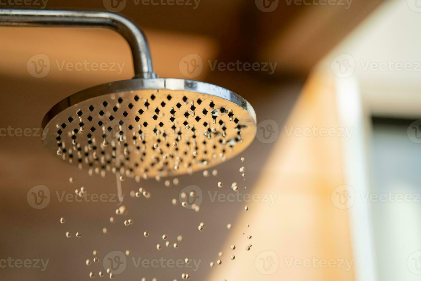 Close up to Outdoor shower head for the bath and showering cold water to body before jumping in the resort pool. photo