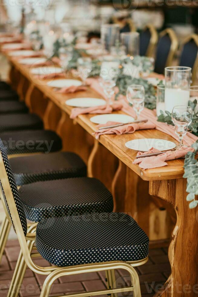 Wedding table setting in a restaurant decorated with flowers and candles photo