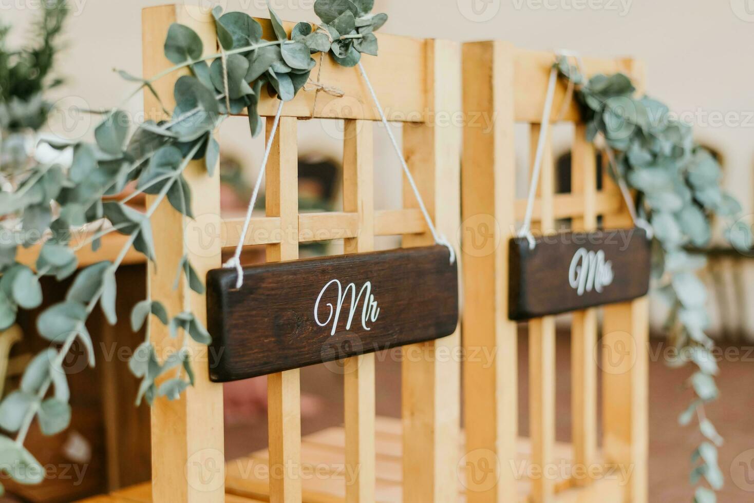 Chairs for bride and groom decorated with flowers with signs mr and mrs for wedding ceremony photo
