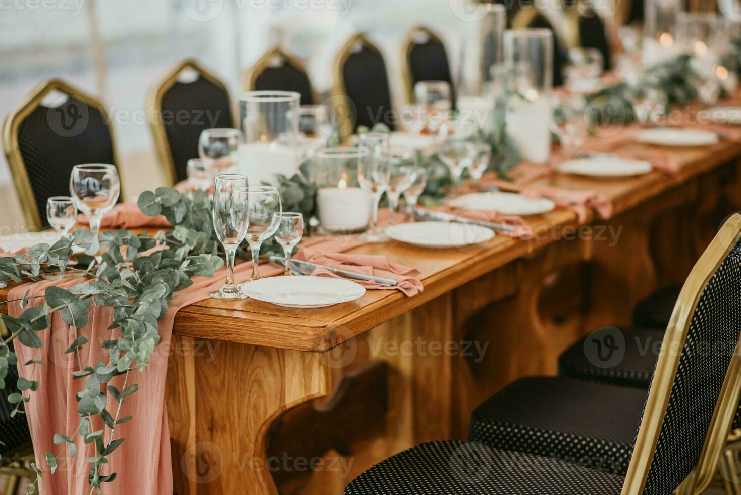 Wedding table setting in a restaurant decorated with flowers and candles photo