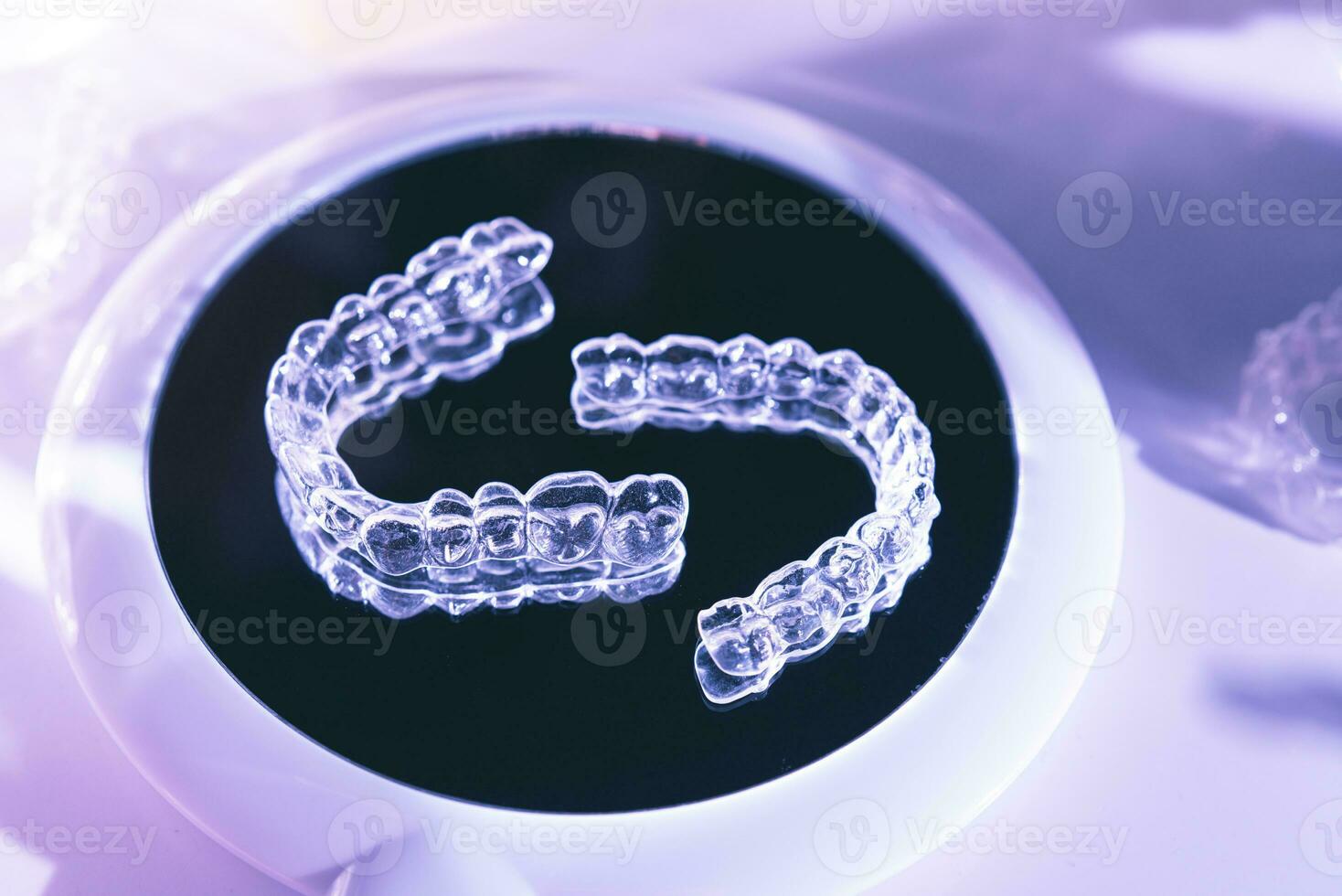 Invisible aligners teeth retainers lie on the mirror photo