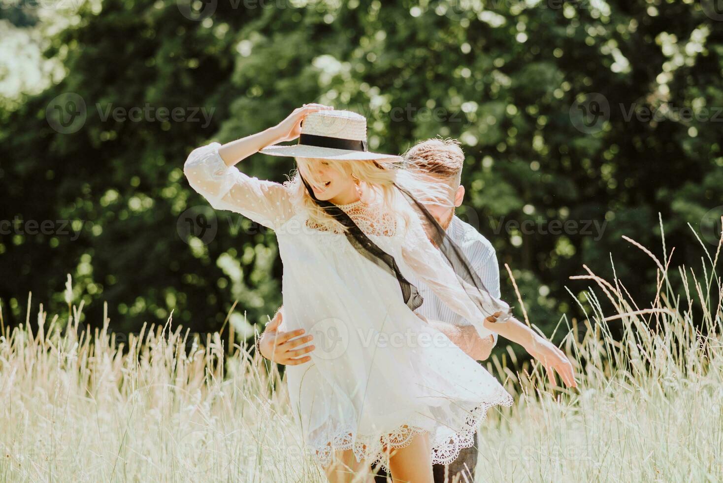 Happy and laughing couple having fun and spending time together on a sunny day in summer photo
