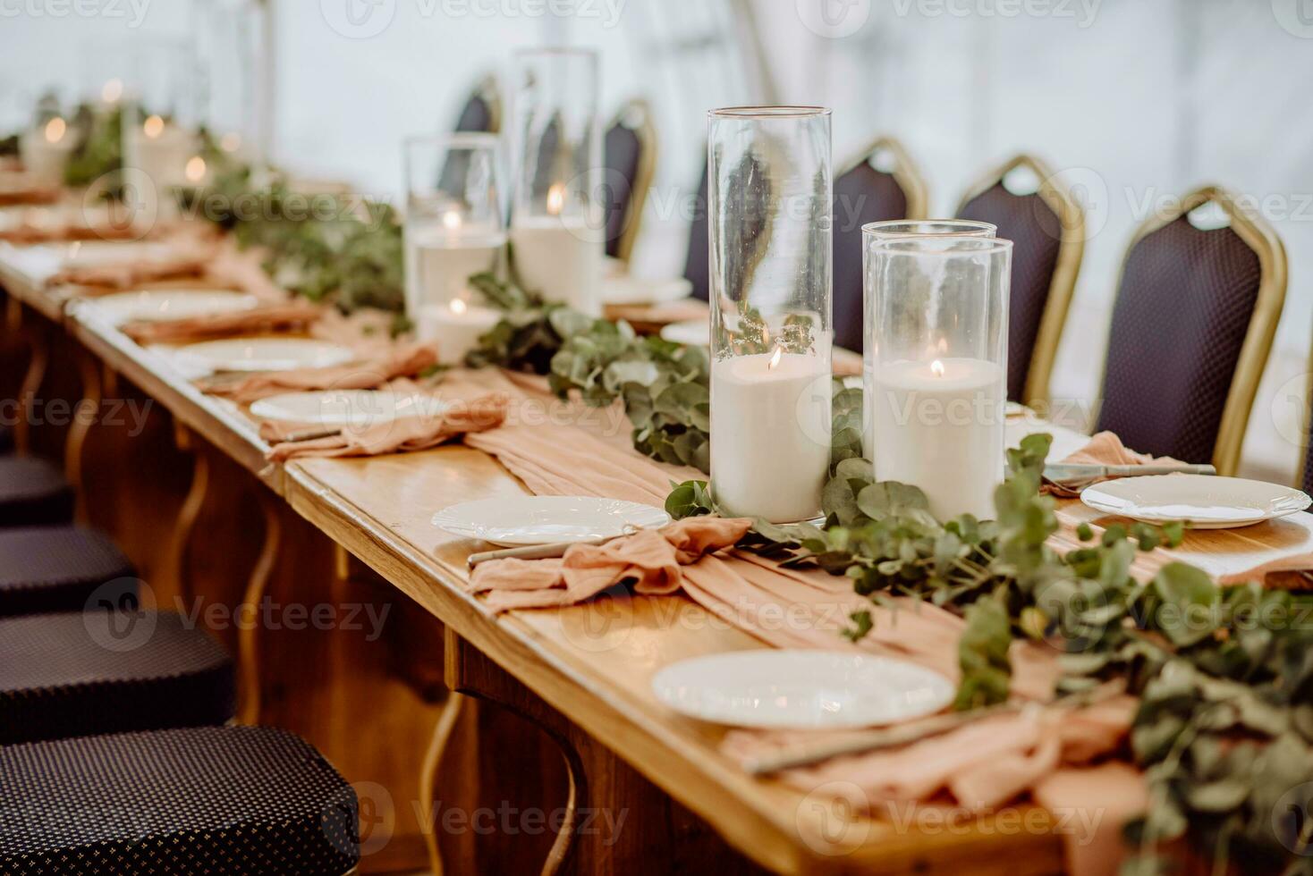 Wedding table setting in a restaurant decorated with flowers and candles photo