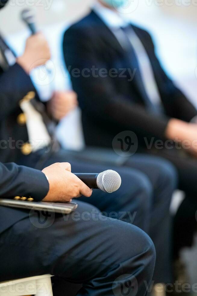 Speaker, who is holding microphone, is discussing how to start business as well as politics, which is difficult topic to find because it is sensitive issue in Thailand. photo