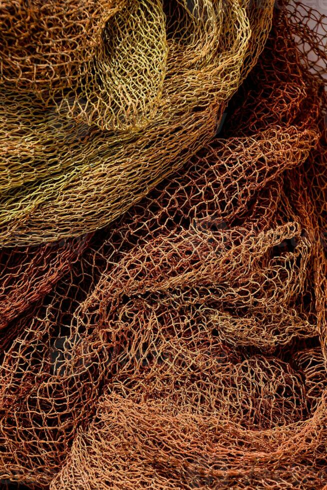 a pile of red and orange fishing nets photo