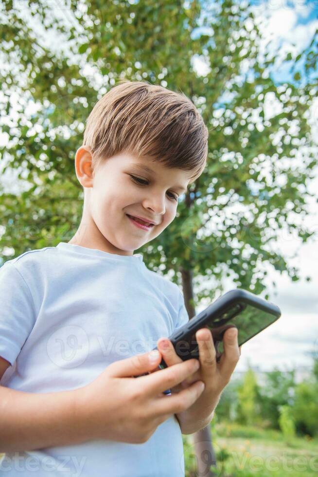 the child speaks on the phone in nature photo