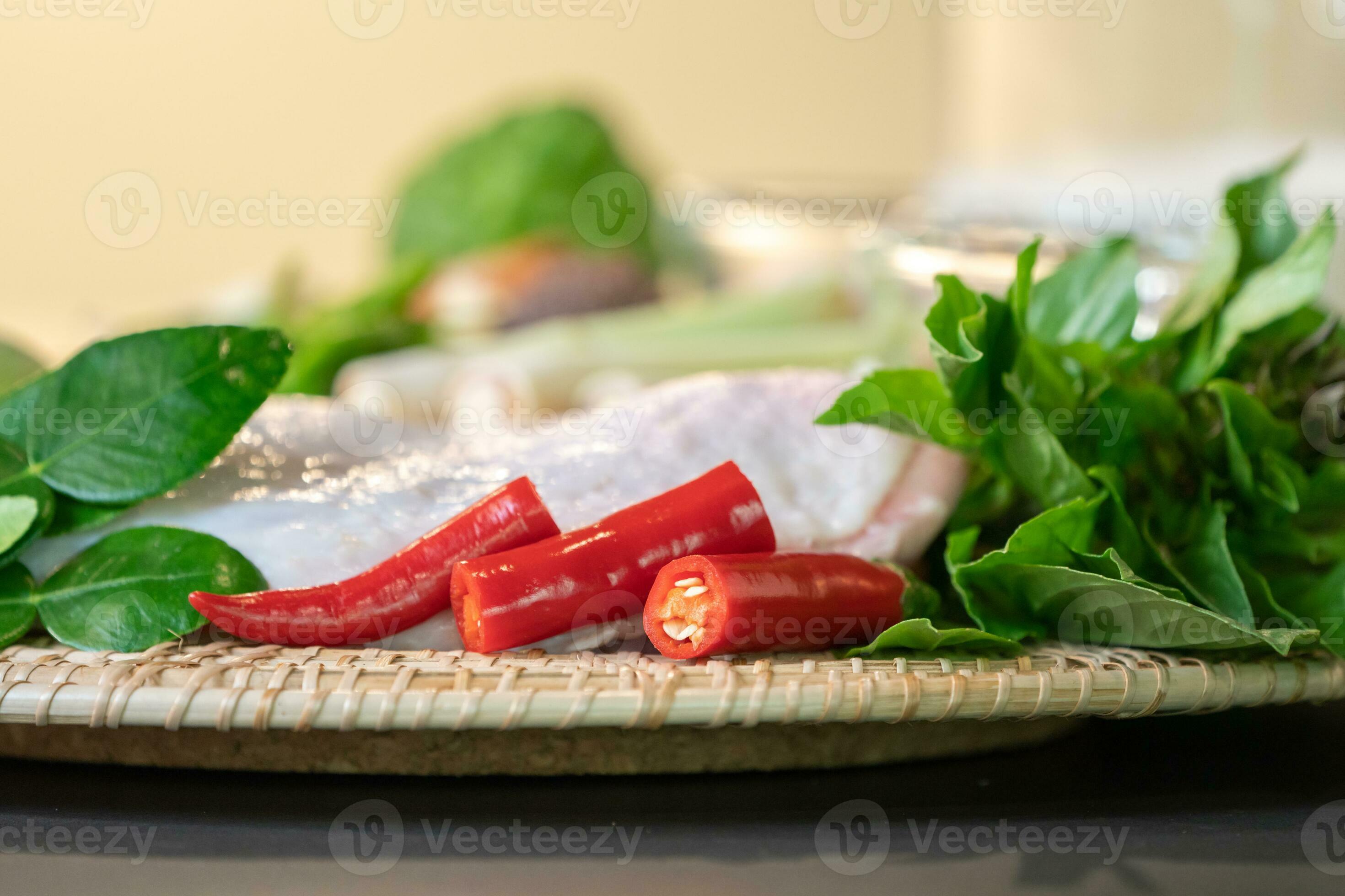 Focusing On Finger Chillies Are Placed Between Basils And Green Herbs focusing-on-finger-chillies-are-placed-between-basils-and-green-herbs