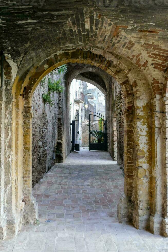 an archway in an old brick building photo