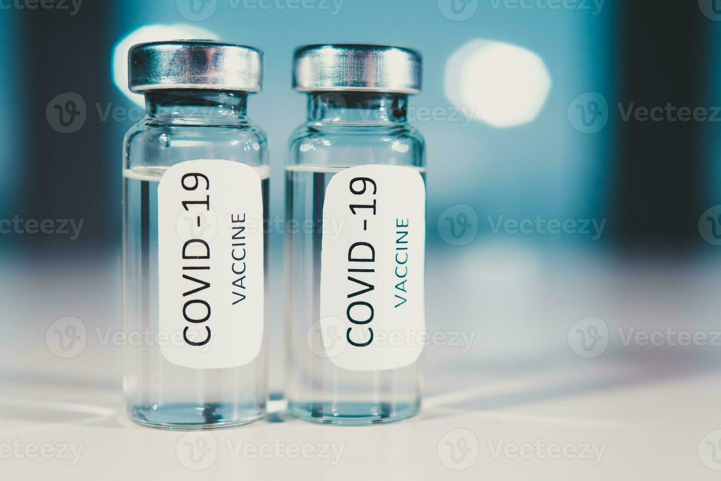 Vaccination against coronavirus COVID - 19. Vial on a blue background close-up. Concept. photo